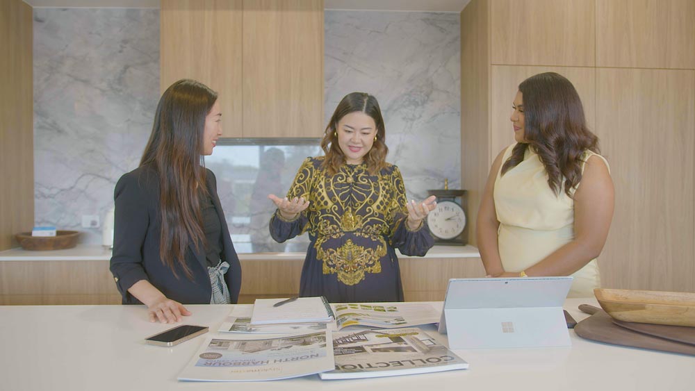 Three women reviewing property plans together in a modern kitchen | Featured image of the Investment Property Agents Home page