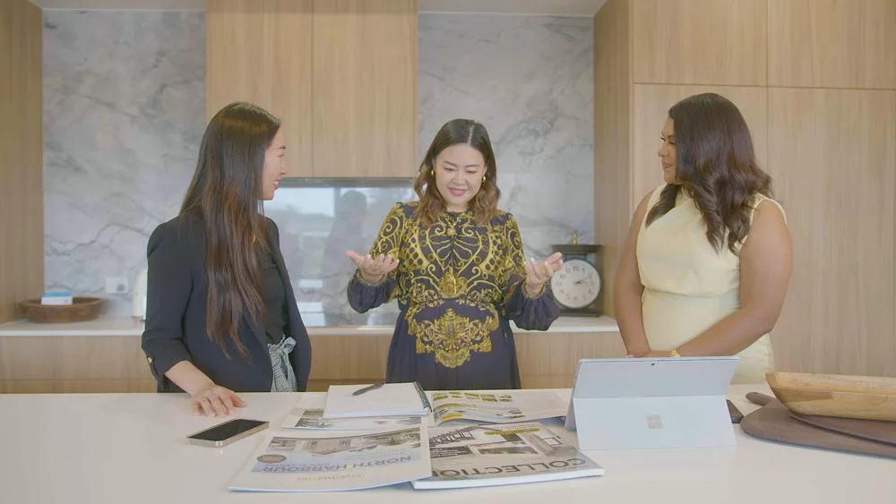 Three professional women standing in a kitchen | Featured image for the investment property financing page.